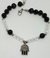 8528 PULSERA PIEDRA NEGRO / BLANCO CON DIJE MANO DE FATIMA 22CM