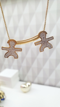 Colar com pingente de dois meninos cravejados, banhado em ouro 18k. - comprar online