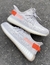 Yeezy 350 Cinza detalhes laranja - OutletFranco