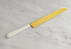Cuchillo para torta de acero dorado y mango de cerámica blanco (28cm)