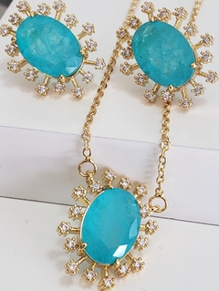 Conjunto dourado com cristal oval azul tiffany e zircônias cristais. - comprar online