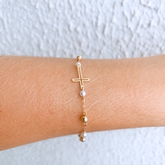 PULSEIRA PÉROLA COM CRUZ OURO 18K AMARELO na internet