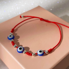 Pulsera hilo rojo 3 ojos azul ajustable