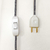 fio listrado revestido de tecido, interruptor e plug branco, graveto design