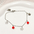 Pulsera fina con dije flor y cristales rojo AQ