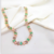 CHOKER COM CRISTAIS RETANGULARES VERDES E ROSAS NO OURO 18K