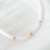 Pulseira cristal rosa com bolinhas douradas ouro na internet