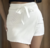 Short Saia Cintura Alta Assimétrico com Amarração Frontal Branco - comprar online