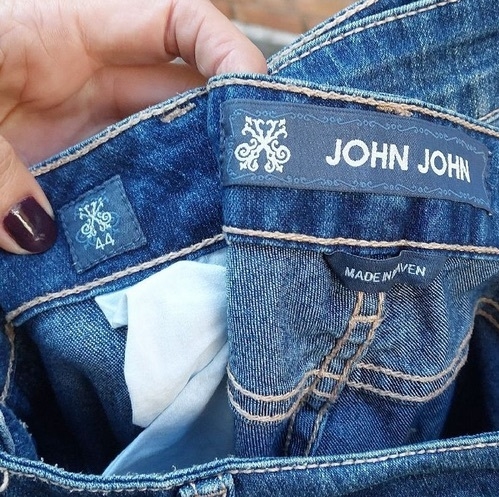 Muitos jeans azuis em cabides à venda no mercado de rua na