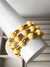 MIX DE PULSEIRAS COM PINGENTES AMARELO