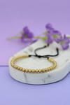 Pulsera balines dorados