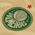 Logotipo do Palmeiras em destaque, com fundo dourado e detalhes em verde, incluindo uma estrela vermelha.