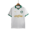 Camisa do Palmeiras, branca com detalhes verdes e logo da Puma, pendurada em um cabide.