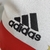 Detalhe do logotipo da Adidas em uma camisa infantil do São Paulo, com destaque para as cores branca e vermelha.

Kit Infantil São Paulo I 22/23, Kit Torcedor Infantil São Paulo 2022/23, Uniforme Infantil São Paulo 22/23
Camisa Infantil São Paulo I 22/23,