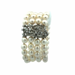 18 kt gold and diamond natural pearl bracelet.