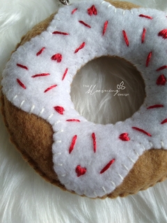 Fun donut with white glaze and red decorations - buy online