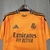 Camisa de goleiro do Real Madrid, cor laranja, com detalhes em preto e logo da Adidas. camisa-camisas-blusa-blusas-uniforme-real-madrid-ii-2-segunda-segundo-24-25-torcedor-adidas-masculina-masculino-laranja-vini-jr-mbappe-bellingham