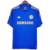 Camisa do Chelsea da temporada 2012 com a cor predominante Azul dom detalhes em dourados nas três listras tradicionais no ombro da adidas com a gola careca seu escudo no lado esquerdo do peito em bordado e no lado direito a logo da adidas.