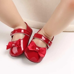 Zapato de goma con moño rojo