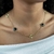 Choker Trevos Dourados e Pedras Pretas Banhado a Ouro 18K - loja online