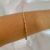 Bracelete Fino com Design Trançado e Fecho Moderno Banhado a Ouro 18K - comprar online