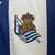 camisa-real-sociedad-home-titular-i-1-azul-royal-branca-24-25-macron-torcedor-masculina-gola-polo-yasuda-group-kutxabank-4.jpg