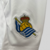 camisa-real-sociedad-home-titular-i-1-azul-royal-branca-24-25-macron-torcedor-unissex-gola-polo-yasuda-group-kutxabank-kit-infantil-short-branco-7.jpg