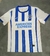 Camisa Brighton Home 24/25 Torcedor Masculina - Azul e Branco, a camisa oficial do seu time! Mostre sua paixão pelo Brighton com a camisa Home 24/25! Compre já a camisa Brighton Home 24/25 Torcedor Masculina - Azul e Branco e torça com estilo! A camisa Br