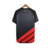 A camisa três do Athletico Paranaense é preta com quatro faixas diagonais vermelhas na parte inferior. Escudo e logo da Umbro também em vermelho, com os diamantes da Umbro em jaquard nas mangas.