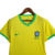 Camisa feminina do Brasil para o Mundial: amarela predominante, detalhes verdes na gola e mangas. Destaque para detalhes em jacquard que remetem a folhas, representando o ecossistema amazônico. Escudo da CBF  e logo da Nike verde.