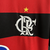 Camisa titular do Flamengo 2010 Olympikus: Camisa com listras rubro-negras, com detalhe na gola em preto. Símbolo de campeão da época no centro. Escudo do Flamengo e logo Olympikus bordados.