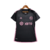 Camisa reserva feminina do Inter Miami, chamada de 'La Noche', é predominantemente preta com listras horizontais em relevo. O rosa 'Bliss Pink' representa a energia vibrante dos fãs e da cidade de Miami à noite. Escudo Inter Miami e logo Adidas em rosa.