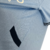 A camisa titular do Manchester City 24/25 mantém o azul celeste predominante, com faixas diagonais azul marinho. Detalhes celestes nos punhos e gola, com o código "0161". Logos PUMA em branco.