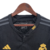 Camisa três do Real Madrid manga longa: preta, versátil e elegante. Três listras cinzas nas mangas, gola redonda com abertura de botão e iniciais RMCF costuradas em amarelo. Escudo amarelo e logo Adidas bodados.