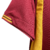 Camisa titular Roma: Vermelha com detalhes amarelos na gola, punhos, laterais e listras dos ombros. Escudo Lupetto histórico, logo Adidas amarelo no peito, frase "Daje Roma Daje" na nuca.