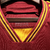 Camisa titular Roma: Vermelha com detalhes amarelos na gola, punhos, laterais e listras dos ombros. Escudo Lupetto histórico, logo Adidas amarelo no peito, frase "Daje Roma Daje" na nuca.