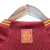 Camisa titular Roma: Vermelha com detalhes amarelos na gola, punhos, laterais e listras dos ombros. Escudo Lupetto histórico, logo Adidas amarelo no peito, frase "Daje Roma Daje" na nuca.