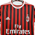 Camisa titular AC Milan 11/12 Adidas: tradicional rubro-negra, com detalhes em branco na gola, nos ombros e nas mangas. Na nuca, bandeiras de Itália e escrito Associazione Calcio Milan. Escudo e logo Adidas bordados.