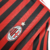 Camisa titular AC Milan 11/12 Adidas: tradicional rubro-negra, com detalhes em branco na gola, nos ombros e nas mangas. Na nuca, bandeiras de Itália e escrito Associazione Calcio Milan. Escudo e logo Adidas bordados.