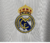 camisa - manga - longa - real madrid - home - 1 - branca - amarelo - azul marinho - escudo - bordado - adidas - torcedor - escudo - bordado - 23/24 - gola - v - emirates fly better - hala  madrid - 5  png .