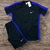 Conjunto masculino Nike Dry-Fit com camiseta preta e detalhes em azul, acompanhado de um short preto.