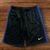 Shorts masculinos Nike Dry-Fit com detalhes em azul e logotipo da marca em branco.