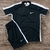 Conjunto masculino Nike Dry-Fit composto por camiseta preta com detalhes em branco e short preto, ambos com o logotipo da Nike.