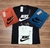 Conjunto de camisas Nike masculinas em suedine 100% algodão, nas cores laranja, preta, branca e azul, exibindo o logotipo Nike.