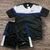 Conjunto Nike Dry-Fit Masculino com camiseta preta e short preto, detalhes em azul e branco.