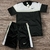 Conjunto Nike Dry-Fit masculino com camiseta preta e short preto, ambos com detalhes em branco e logo da Nike.