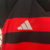 Conjunto infantil do Flamengo I 24/25 da Adidas, com camiseta preta e vermelha listrada e calção branco.