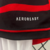 Conjunto infantil do Flamengo I 24/25 da Adidas, com camiseta preta e vermelha listrada e calção branco.