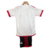 Conjunto infantil do Flamengo II 24/25 da Adidas, com camiseta branca e detalhes em vermelho, e calça curta preta com listras vermelhas.