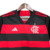 Camisa feminina do Flamengo, modelo 24/25, nas cores vermelha e preta, com listras horizontais e logo da Adidas.